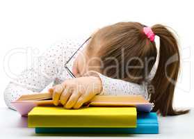 Cute little girl is sleeping on a book