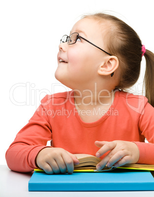 Cute little girl reading book