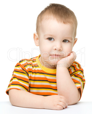 Portrait of a cute little boy looking at something