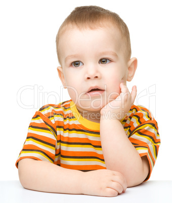 Portrait of a cute little boy looking at something