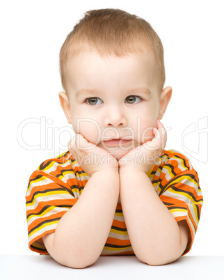 Portrait of a cute little boy looking at something