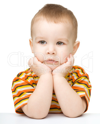 Portrait of a cute little boy looking at something