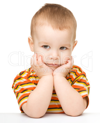 Portrait of a cute little boy looking at something