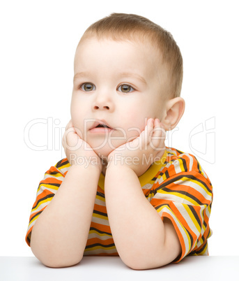 Portrait of a cute little boy looking at something