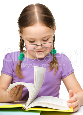 Cute cheerful little girl with book