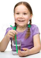 Cute little girl with a glass of water