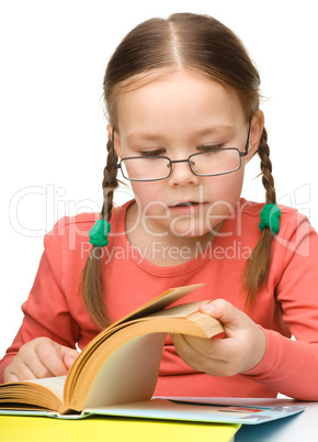 Cute little girl reading book