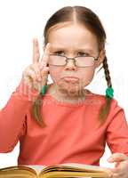 Sad little girl showing "Victory" gesture