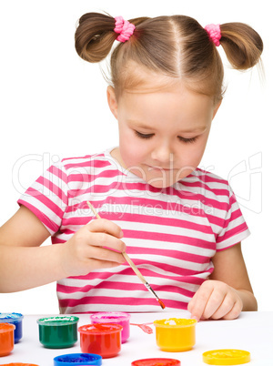 Cute cheerful child play with paints