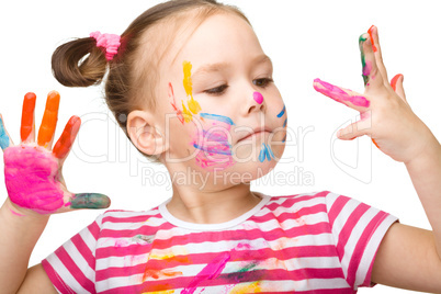 Portrait of a cute girl playing with paints