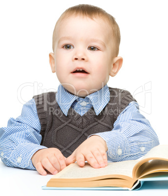 Portrait of a cute little boy with books