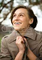 Portrait of a happy beautiful woman in autumn park