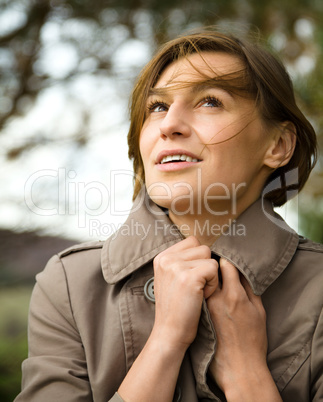 Portrait of a happy beautiful woman in autumn park