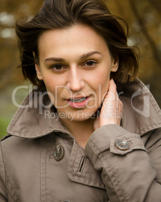 Portrait of a happy beautiful woman in autumn park
