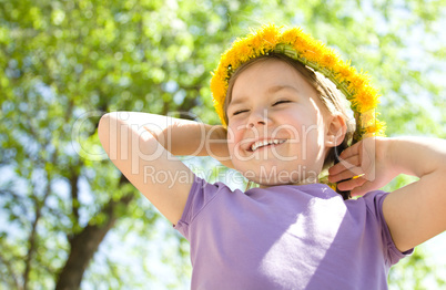 Portrait of a little girl with dandelion wreath