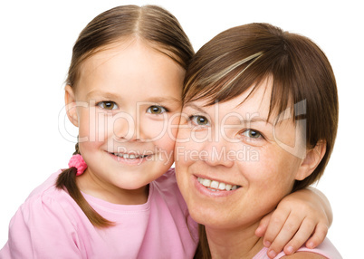 Portrait of a happy mother hugging her daughter