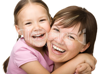 Portrait of a happy mother hugging her daughter