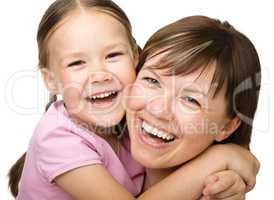 Portrait of a happy mother hugging her daughter