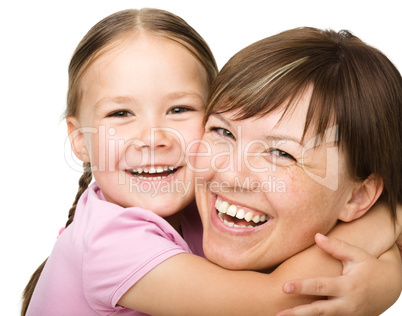 Portrait of a happy mother hugging her daughter