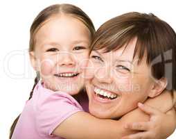 Portrait of a happy mother hugging her daughter