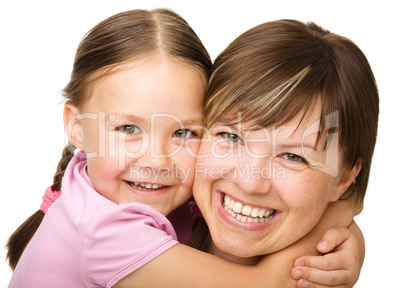 Portrait of a happy mother hugging her daughter