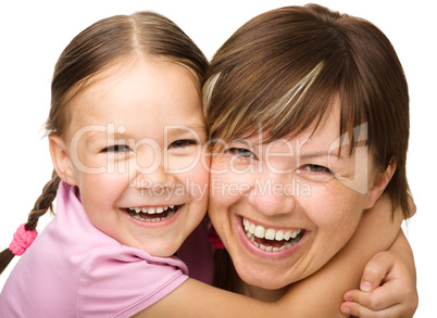 Portrait of a happy mother hugging her daughter