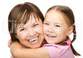 Portrait of a happy mother hugging her daughter