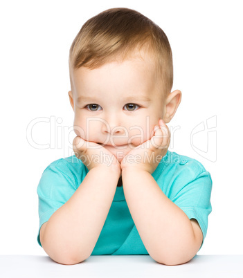 Portrait of a cute little boy looking at something