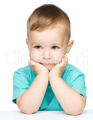 Portrait of a cute little boy looking at something