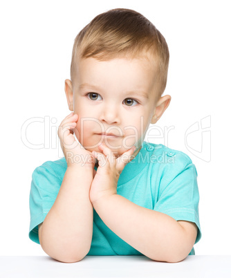 Portrait of a cute little boy looking at something