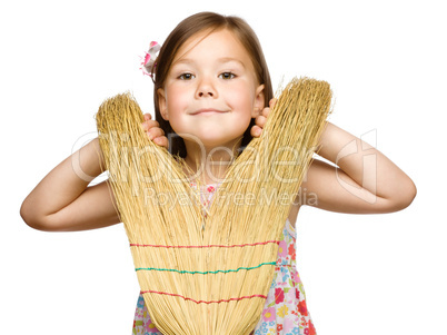 Portrait of a little girl with broom