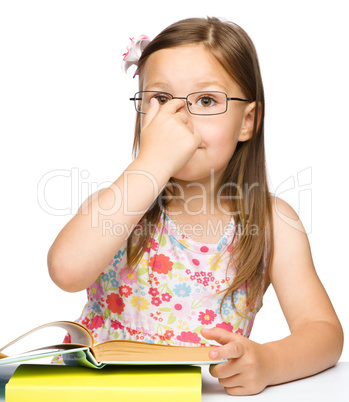 Cute cheerful little girl with book