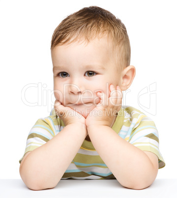 Portrait of a cute little boy looking at something