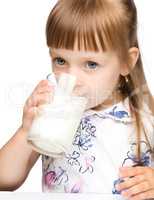 Cute little girl drinks milk