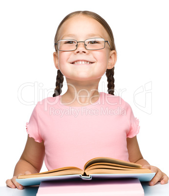 Cute little schoolgirl with a book