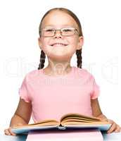Cute little schoolgirl with a book