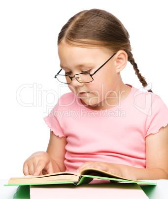 Cute little schoolgirl with a book