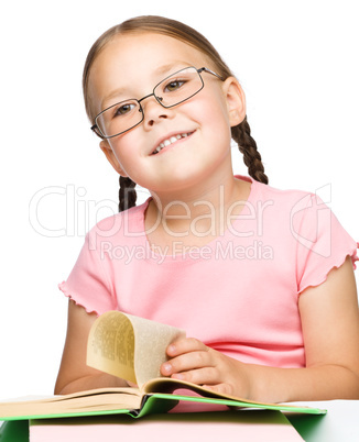 Cute little schoolgirl with a book