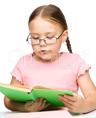 Cute little schoolgirl with a book