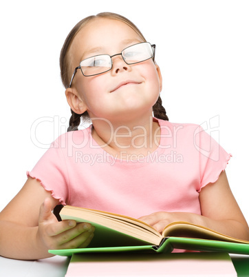 Cute little schoolgirl with a book