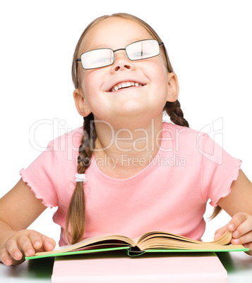 Cute little schoolgirl with a book