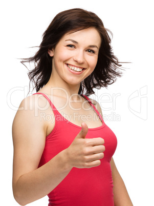 Woman is showing thumb up gesture