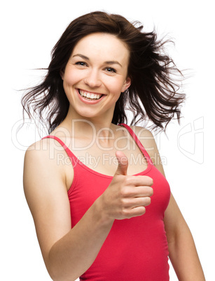 Woman is showing thumb up gesture