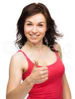 Woman is showing thumb up gesture