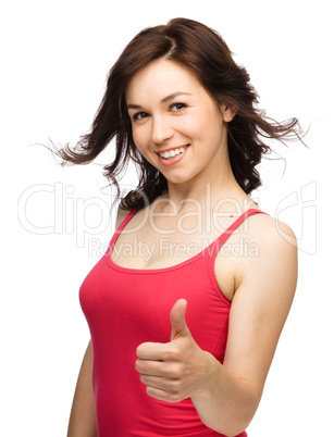 Woman is showing thumb up gesture