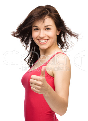 Woman is showing thumb up gesture