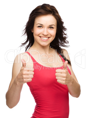 Woman is showing thumb up gesture