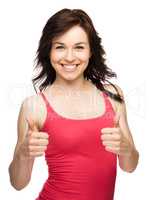 Woman is showing thumb up gesture