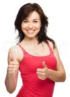 Woman is showing thumb up gesture