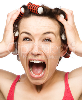 Woman is screaming holding her head with hands
